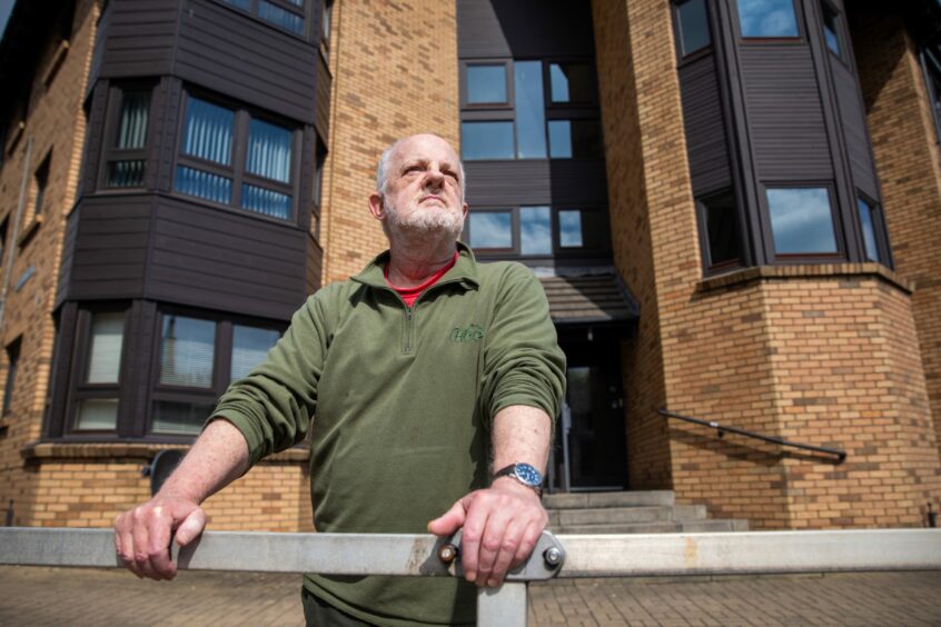 Graeme outside his former workplace - which is now sheltered housing. Image: Kim Cessford/DC Thomson.