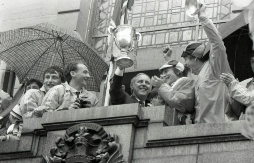 On the balcony, legendary Dundee United manager Jim McLean celebrates his finest hour. Image: DC Thomson.