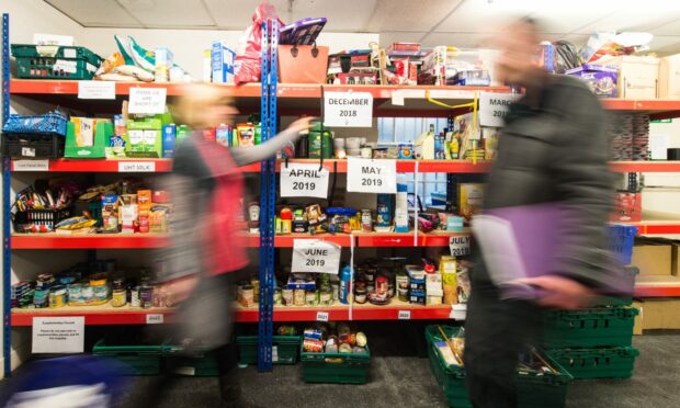 Shelves full of products at a food bank, which is coming under increasing pressure due to just how much food prices have gone up.