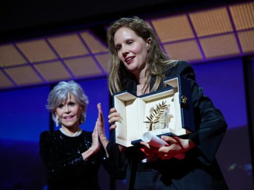 Justine Triet, right, accepts the Palme d’Or for ‘Anatomy of a Fall,’ which was presented by Jane Fonda, left, during the awards ceremony of the 76th international film festival, Cannes, southern France (Daniel Cole/AP)