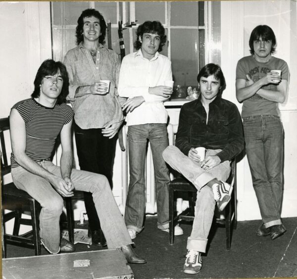 AC/DC enjoying a few drinks backstage at the Caird Hall in Dundee, 1978.