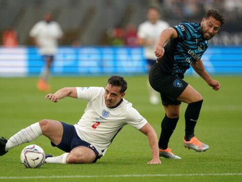 England’s Gary Neville and World XI’s Kem Cetinay compete for the ball (Zac Goodwin/PA)