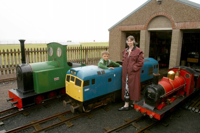 Jill and her son John with some of the rolling stock after taking charge of Kerr's miniature railway in 2006. Image: DC Thomson.