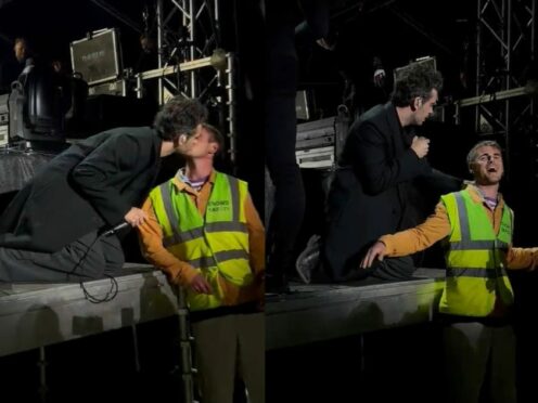Matty Healy kissed a man in a hi-vis jacket mid-performance in Denmark on Friday (@EmChrisL/Twitter)