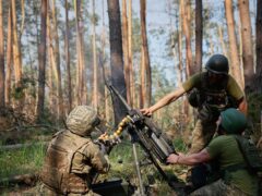 Ukrainian soldiers fire a grenade launcher towards the Russian positions on the frontline (Roman Chop via AP)