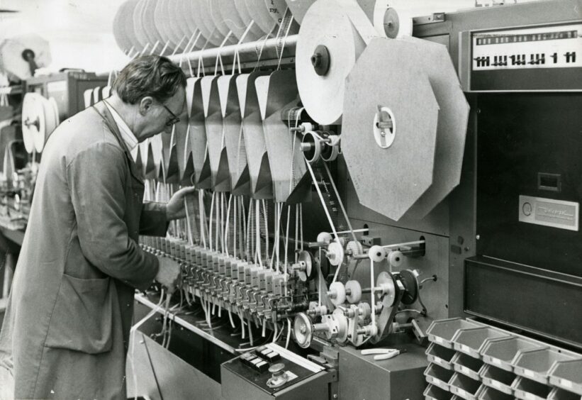 Henry Cox is holding parts of the machine. Image: DC Thomson.