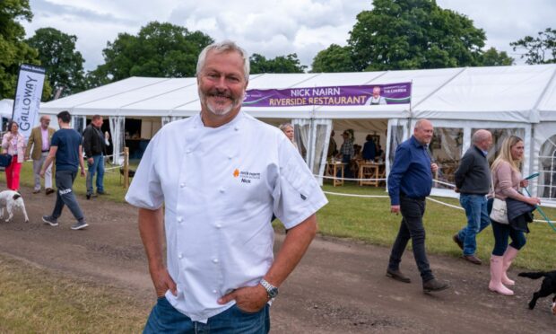 Nick Nairn wearing a chef's jacket outside pop-up Riverside Restaurant at the Scottish Game Fair.