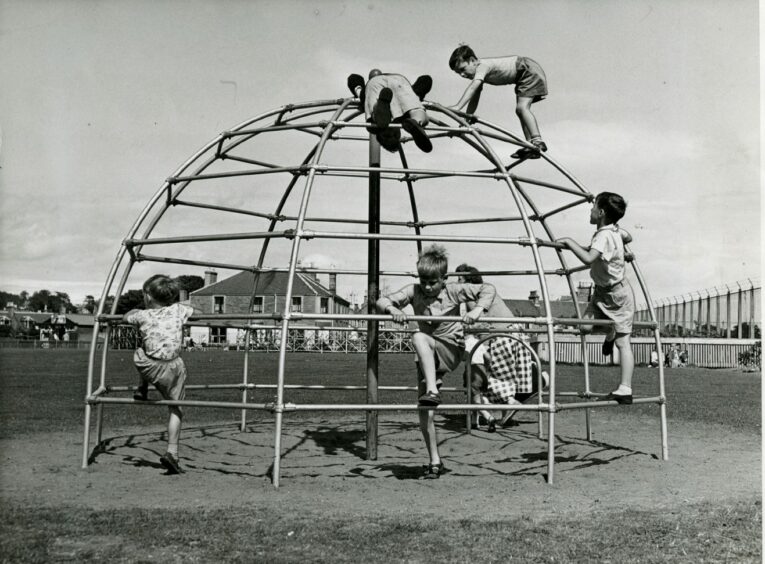 Children play on the new igloo climbing frame on Castle Green in July 1960. Image: DC Thomson.