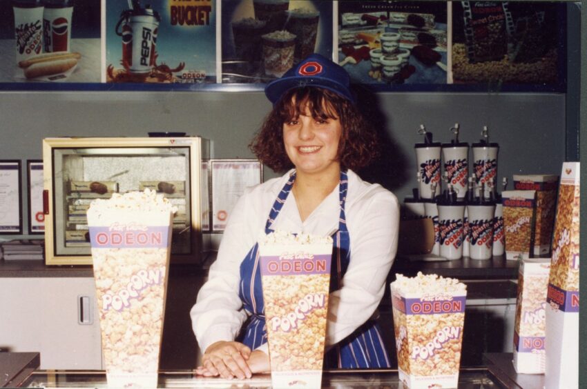 Jackie Reddichan serves behind the food bar at the Odeon.