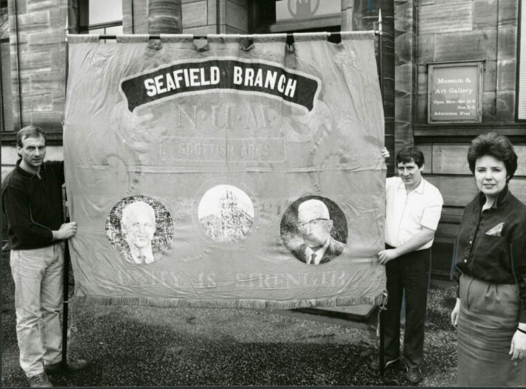 A Seafield Branch NUM banner is handed over to Kirkcaldy Museum following the closure. Image: DC Thomson.