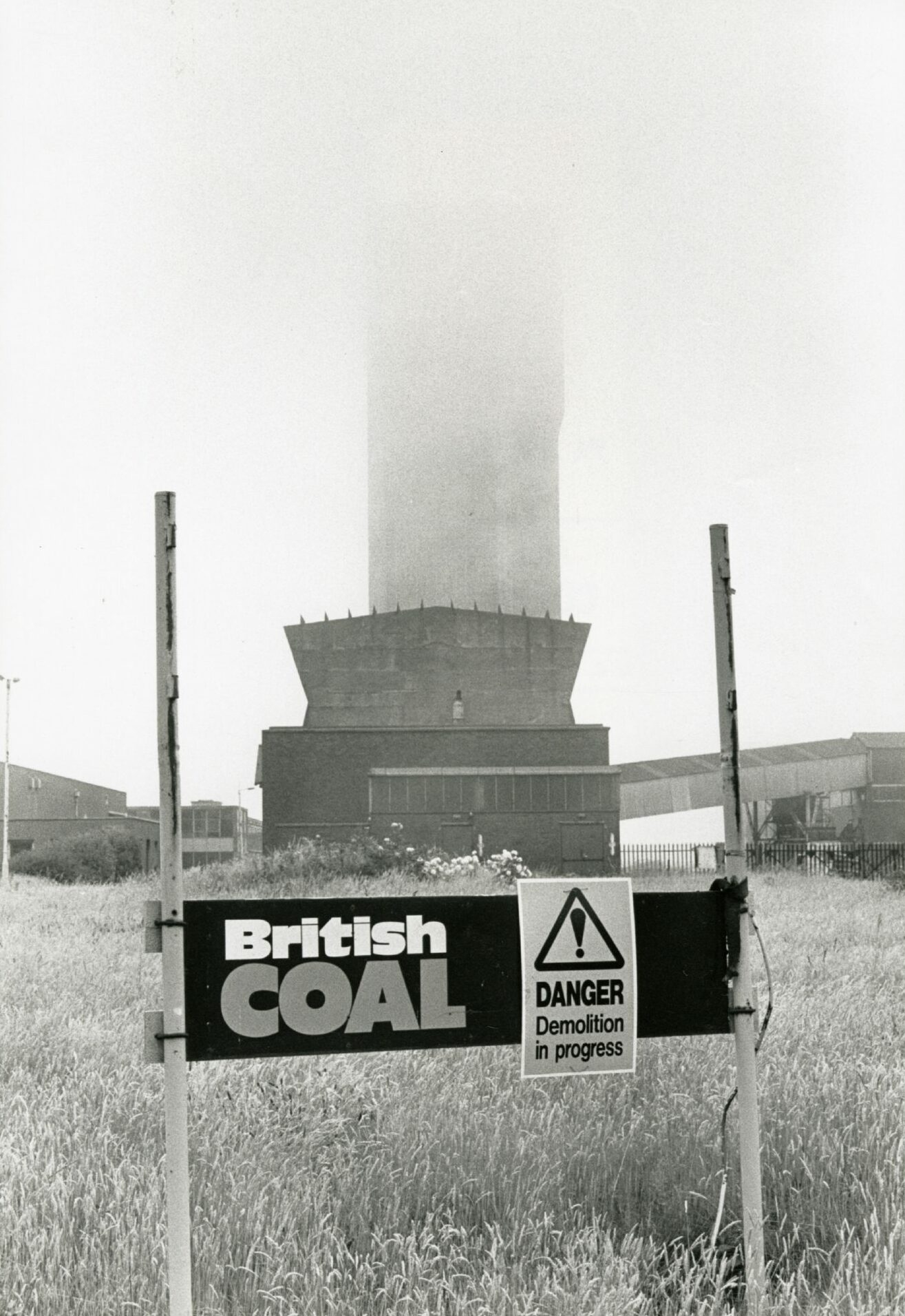 A sign indicating demolition work at Seafield Colliery, visible in the background.