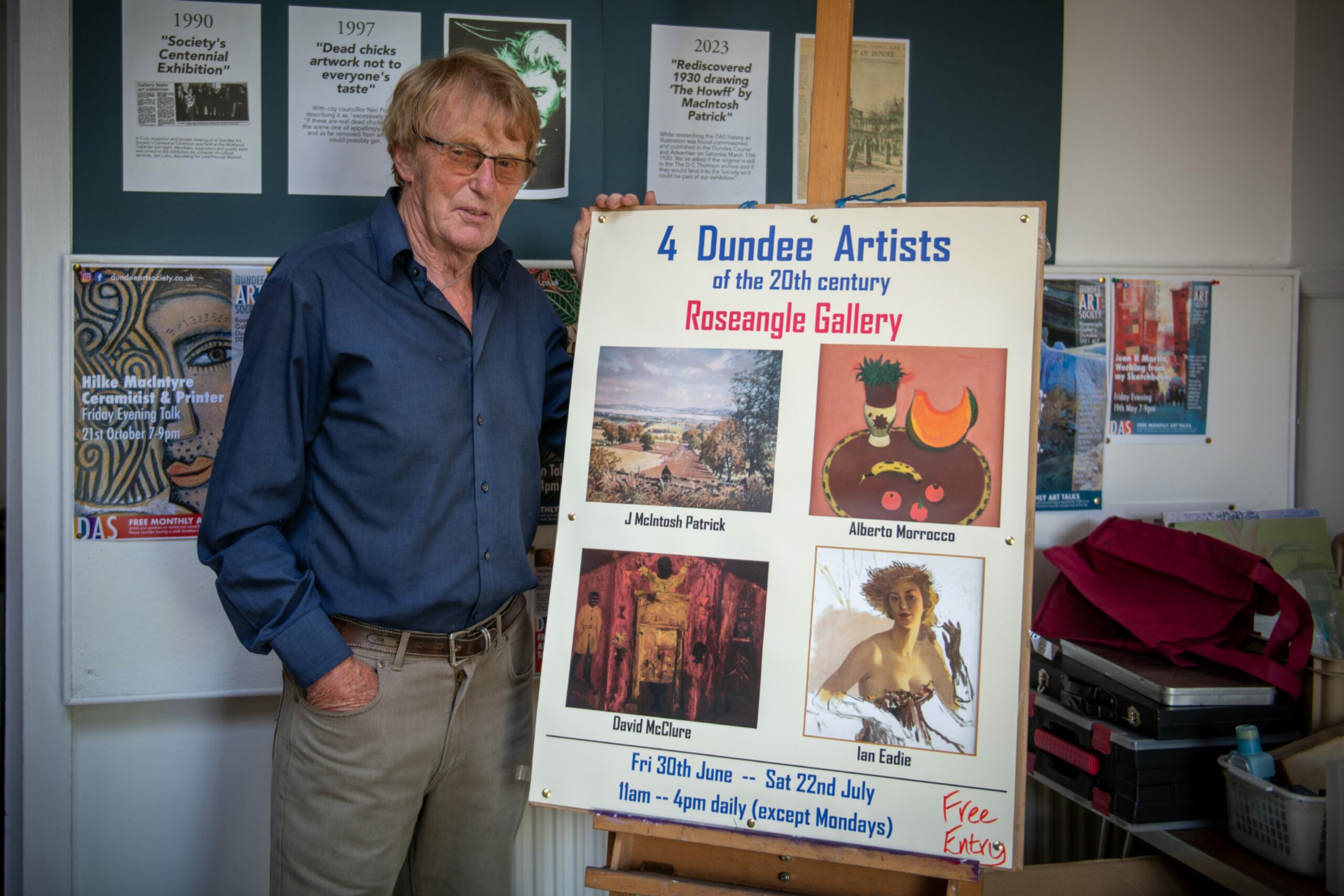 Alan Lawson from Dundee Art Society with the Four Dundee Artists exhibition poster.