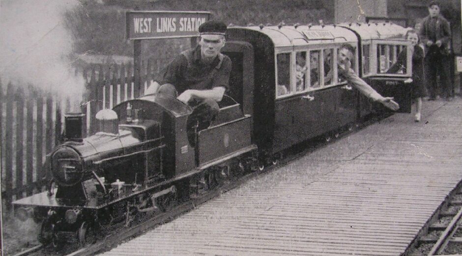 The Pullman coaches being pulled by a locomotive