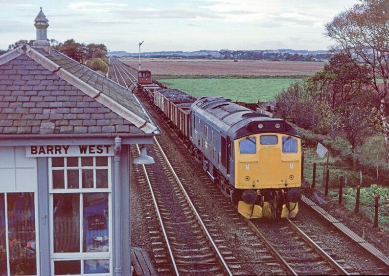 A British Rail Class 25 diesel locomotive passing the Barry West signal box back in 1979. Image: Brian Livie.