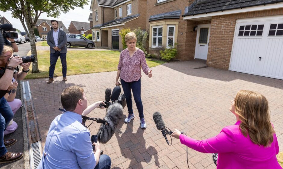 Former first minister of Scotland Nicola Sturgeon speaks to the media outside her home in after she was arrested. Image: PA