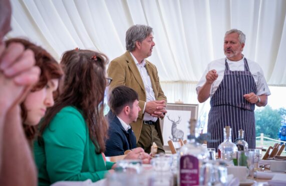 Nick Nairn inside a pop-up restaurant in a marquee talking to diners.