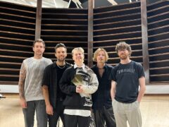 Nothing But Thieves pose with their number one album award from the Official Charts Company for Dead Club City (Official Charts Company)