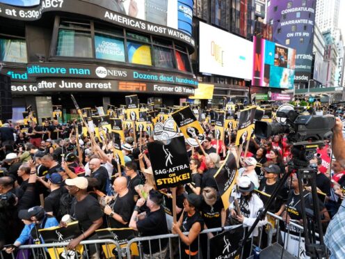People holding picket signage attend the Sag-Aftra “Rock the City for a Fair Contract” rally in Times Square (Charles Sykes/Invision/AP)
