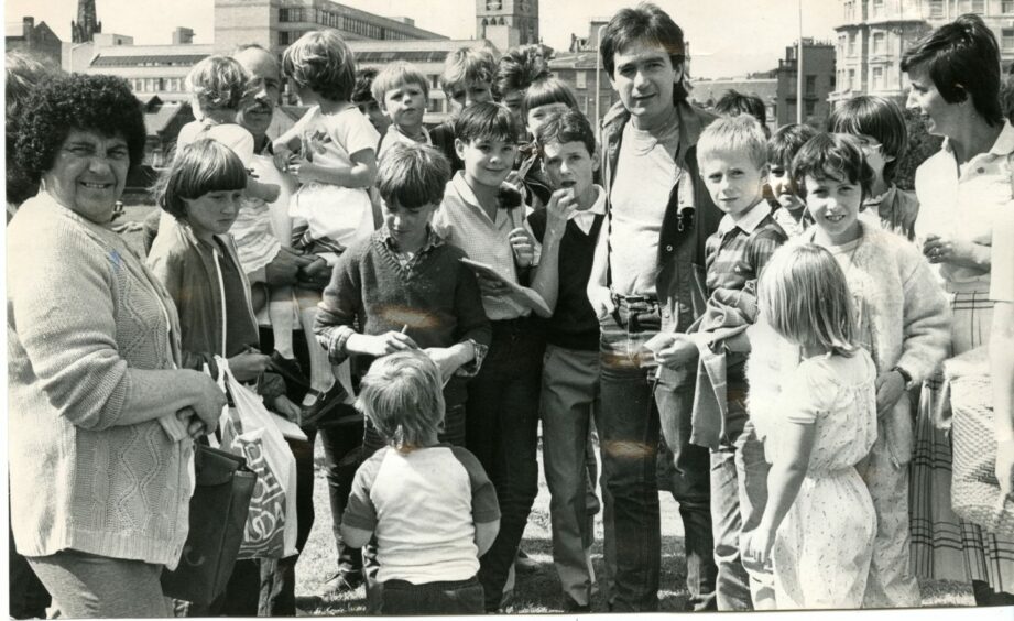 The Untied Shoelace Show's bus visited Dundee in August 1983. Here presenter Tiger Tim Stevens signs autographs for the excited crowd.
