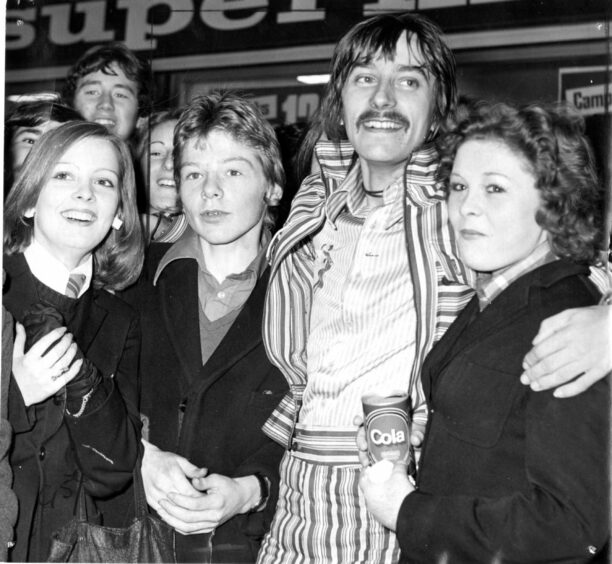 Fans outside the Overgate in Dundee in November 1973 with DJ Stuart Henry (second right).