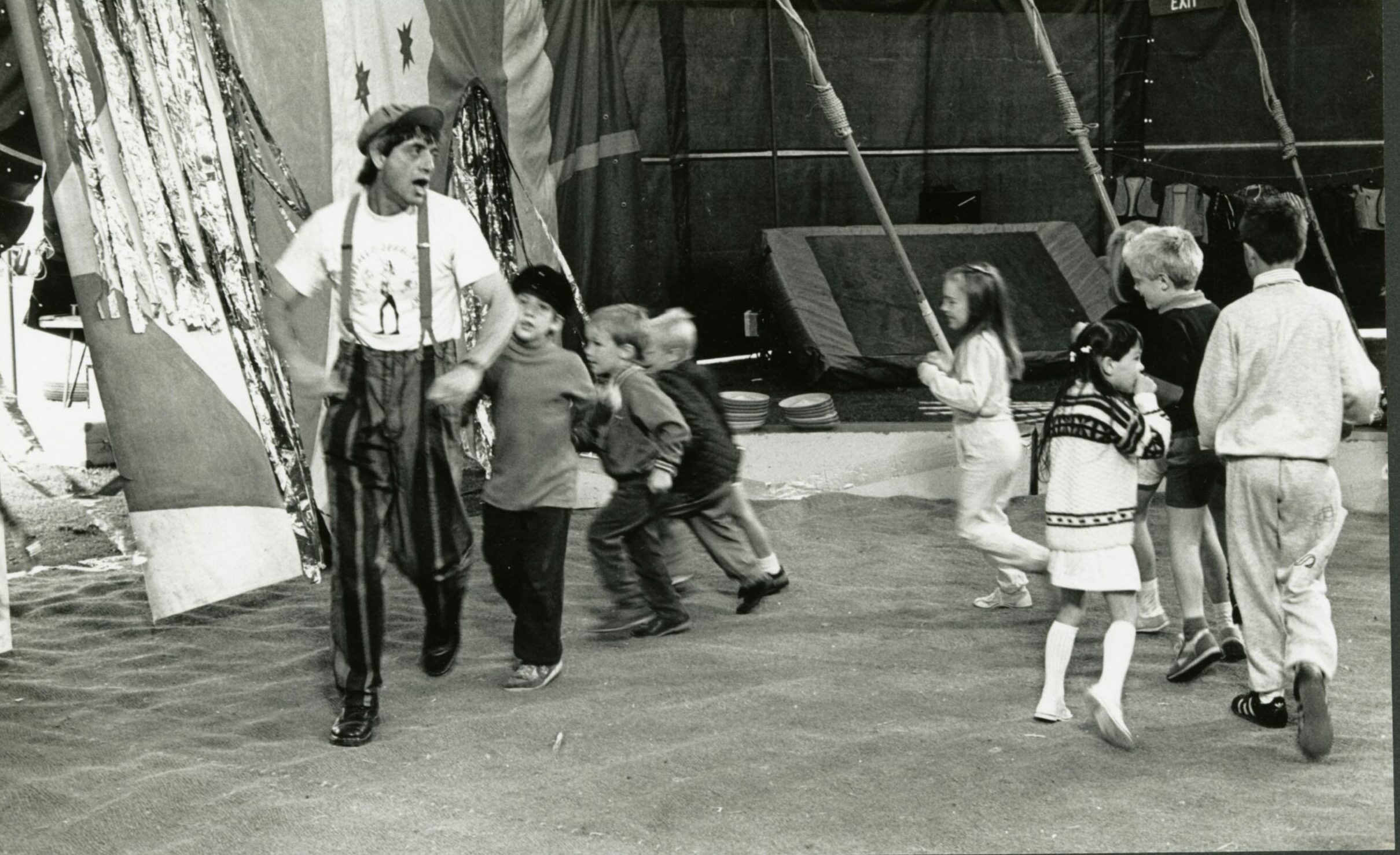 Children follow a performer around inside the Circus Big Top