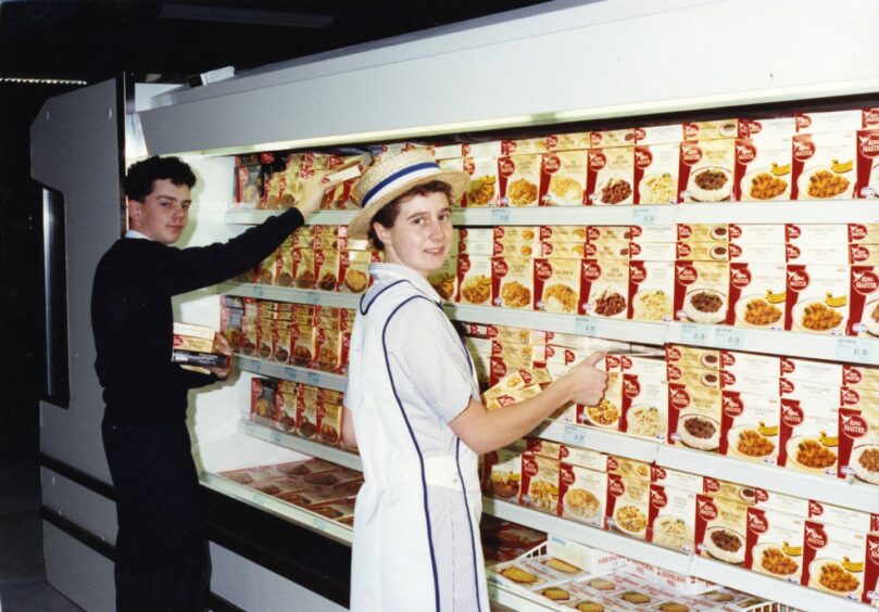 Helen Jamieson and Keith Gibson fill the shelves at Norco ahead of the store opening in 1990. Image: DC Thomson. 