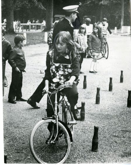 Nine year-old Alison Walker gets on her bike in Dundee 1973. 