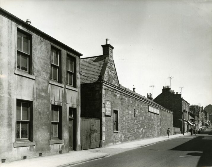 Fish cannery factory in South Road with a pedestrian walking past. Image: DC Thomson.