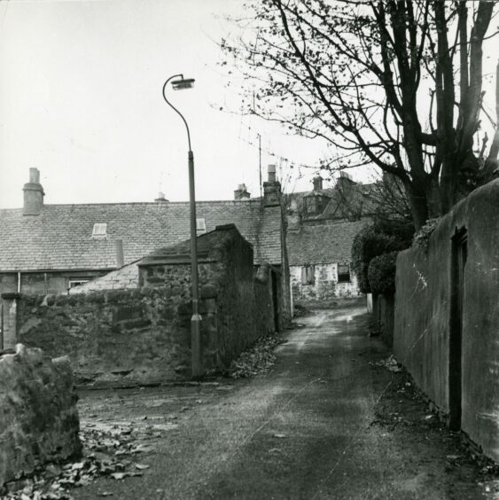 The alley is shown with debris on the road. Image: DC Thomson.