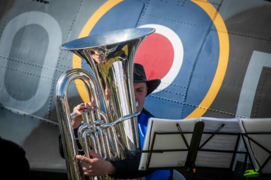 Forfar Brass Band in front of an old war plane.