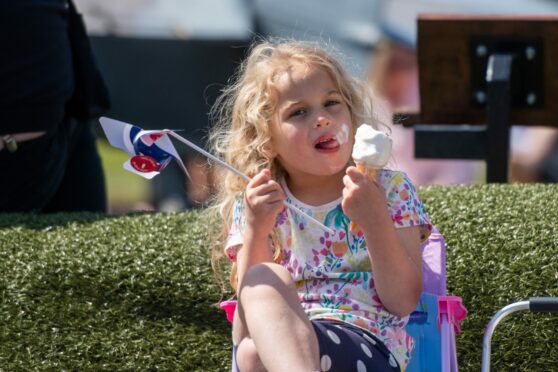 A young girl called Caragh Howe eats her ice cream.