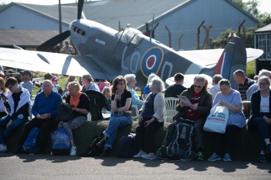 Crowds gathered in front of war plane at the Montrose Air Station.