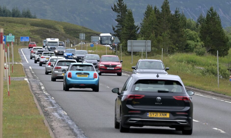 Busy traffic, both north and south, on a single carriageway section of the A9 as it crosses Drumochter. 