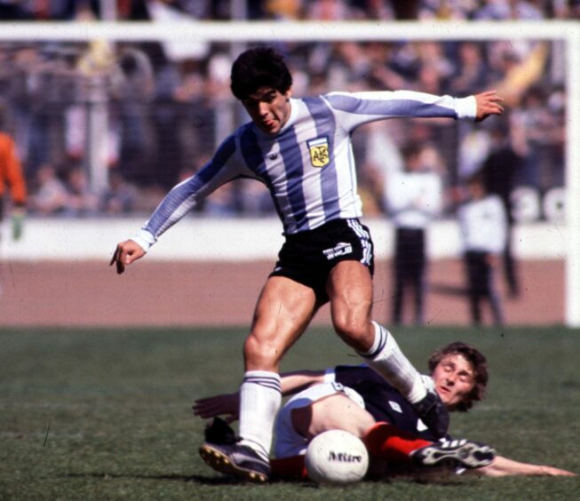 Diego Maradona skips past another challenge from Paul Hegarty at Hampden in 1979. Image: SNS.