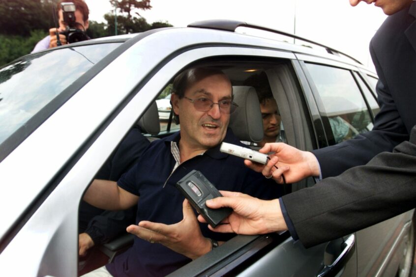 Giovanni di Stefano speaks to reporters from his car