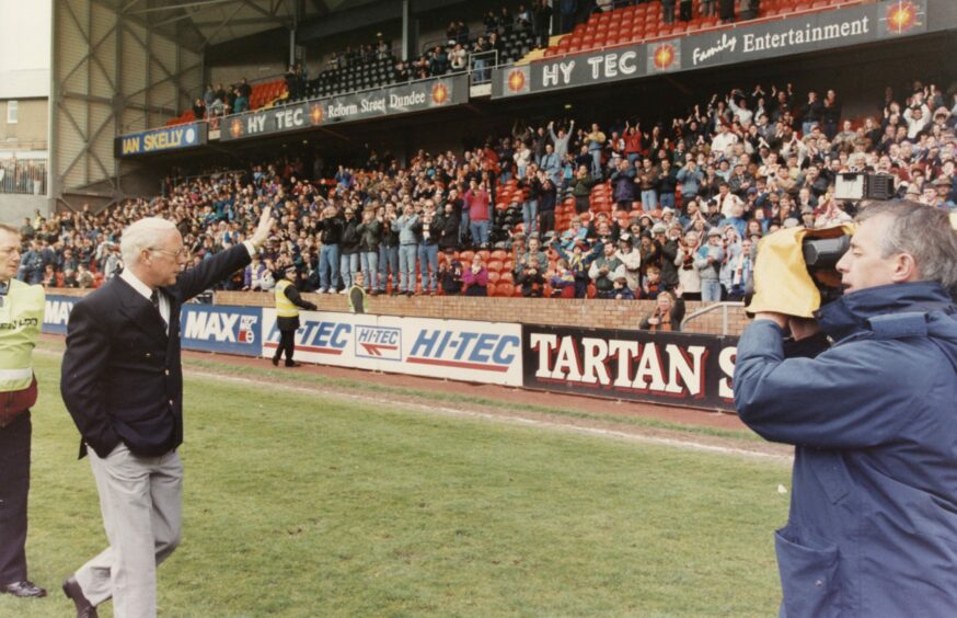 Jim McLean waves to the Dundee United fans from the Tannadice Park pitch.
