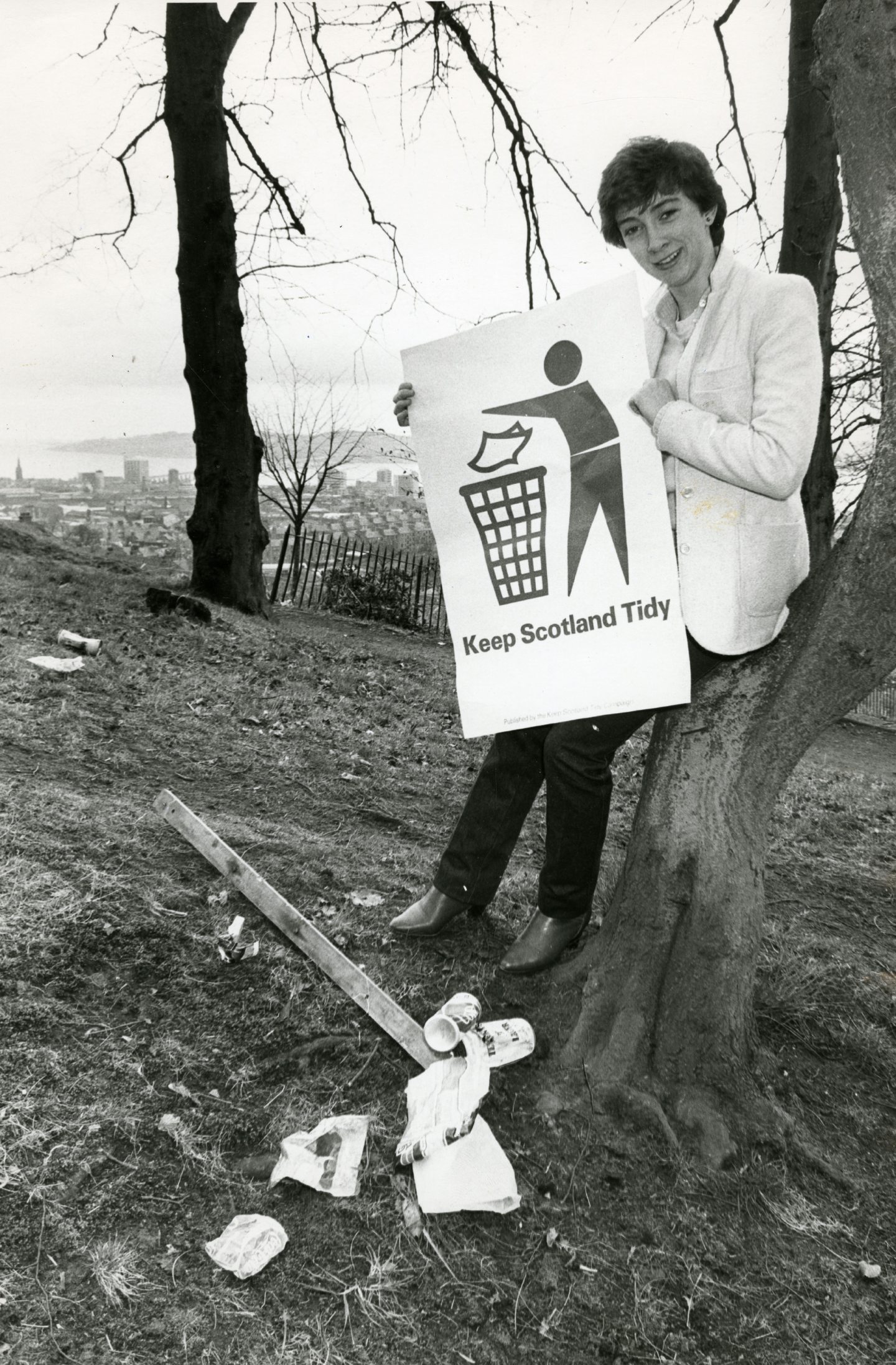 A woman holds Keep Scotland Tidy campaign poster. Image: DC Thomson.