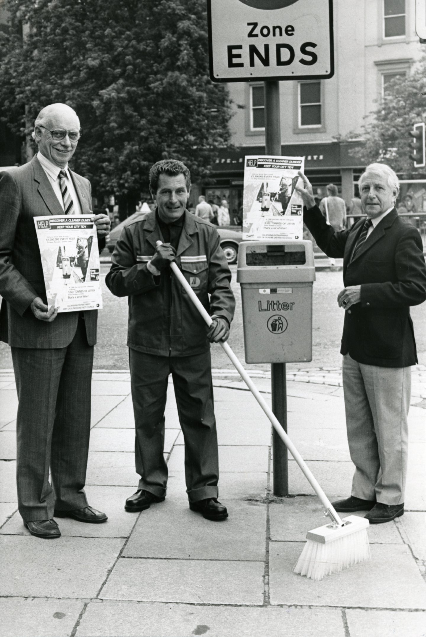 Three men beside a bin in a Keep Dundee Tidy campaign launch. Image: DC Thomson.