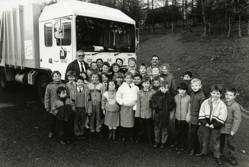 Pictured with the children are project supervisor Ron Brown and bin lorry driver John Hutchison. Image: DC Thomson.