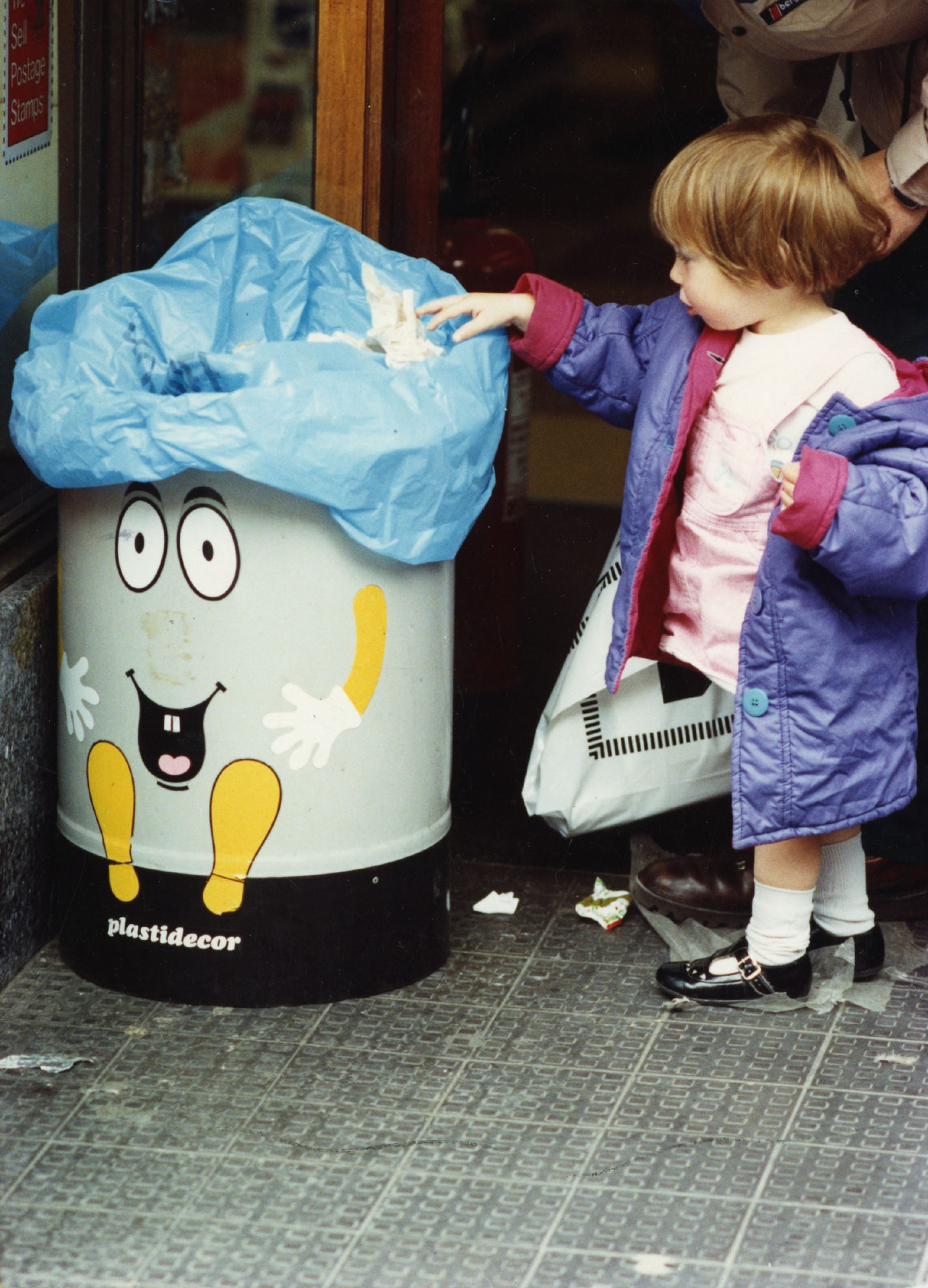 A girl puts liiter in a bin at McColl's Reform Street. Image: DC Thomson.