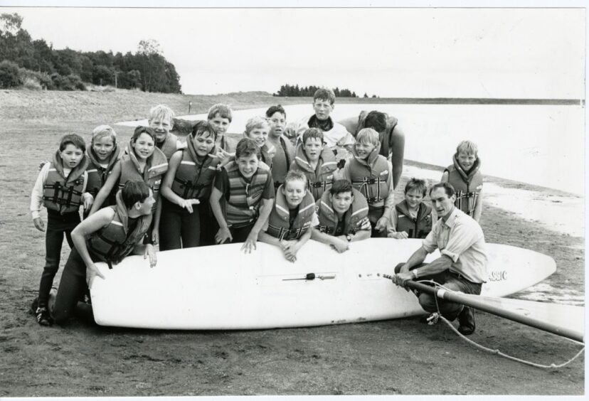 Children line up for a photograph before paddle boarding at Clatto Country Park. 