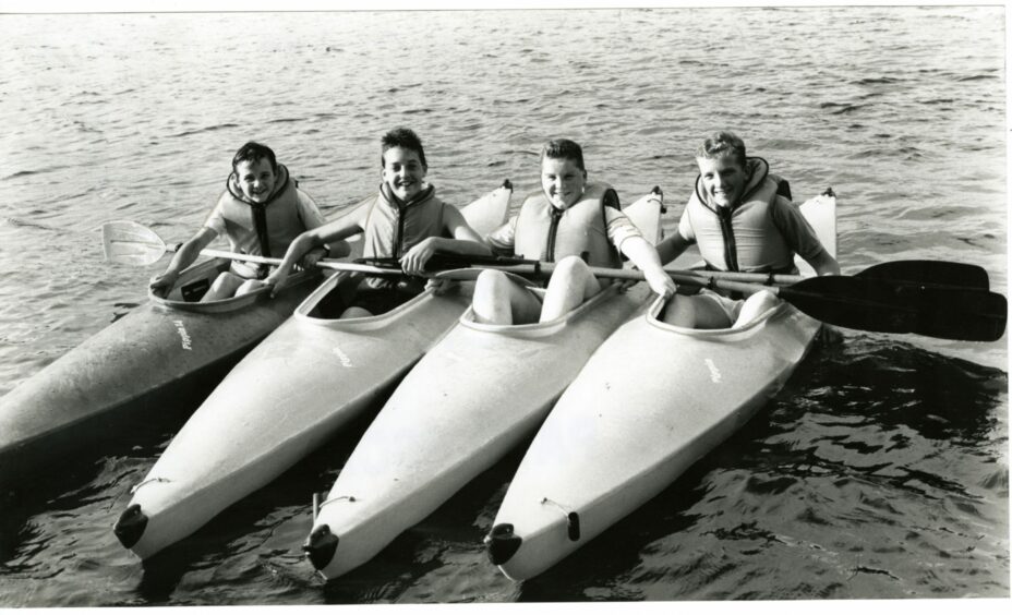 A group of boys enjoying the sunny day at Clatto Park in their kayaks