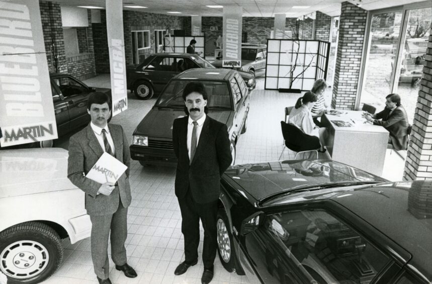 Showroom showing several cars and staff speaking to customers. Image: DC Thomson.