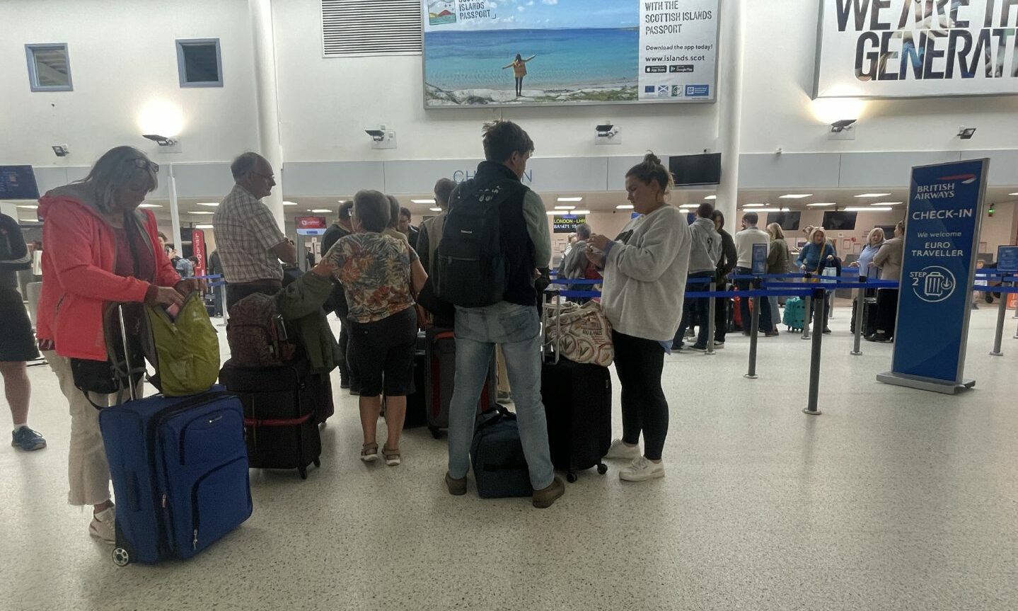 Queuing British Airways passengers at check-in desks at Inverness Airport. 