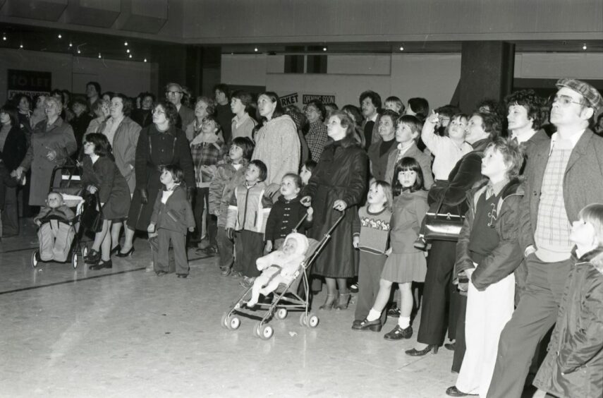 These shoppers stand mesmerised as the clock springs into action after being installed in September 1978. Image: DC Thomson.