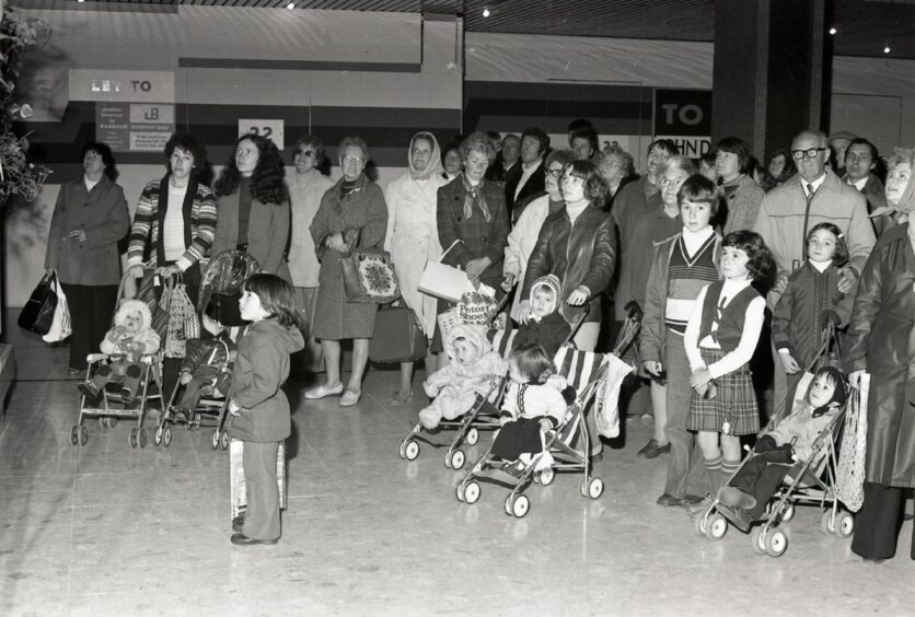 Crowds gather to watch the The Wellgate Clock chime.