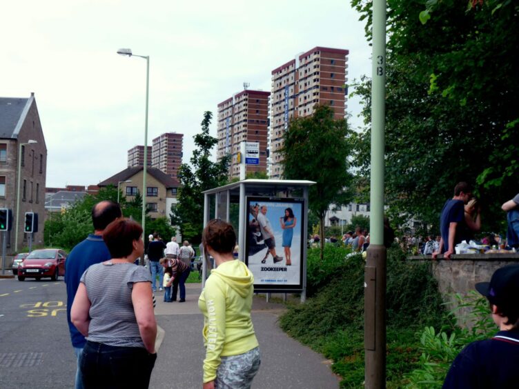 People gather to watch the tower blocks tumble in July 2011. Image: Front Lounge.
