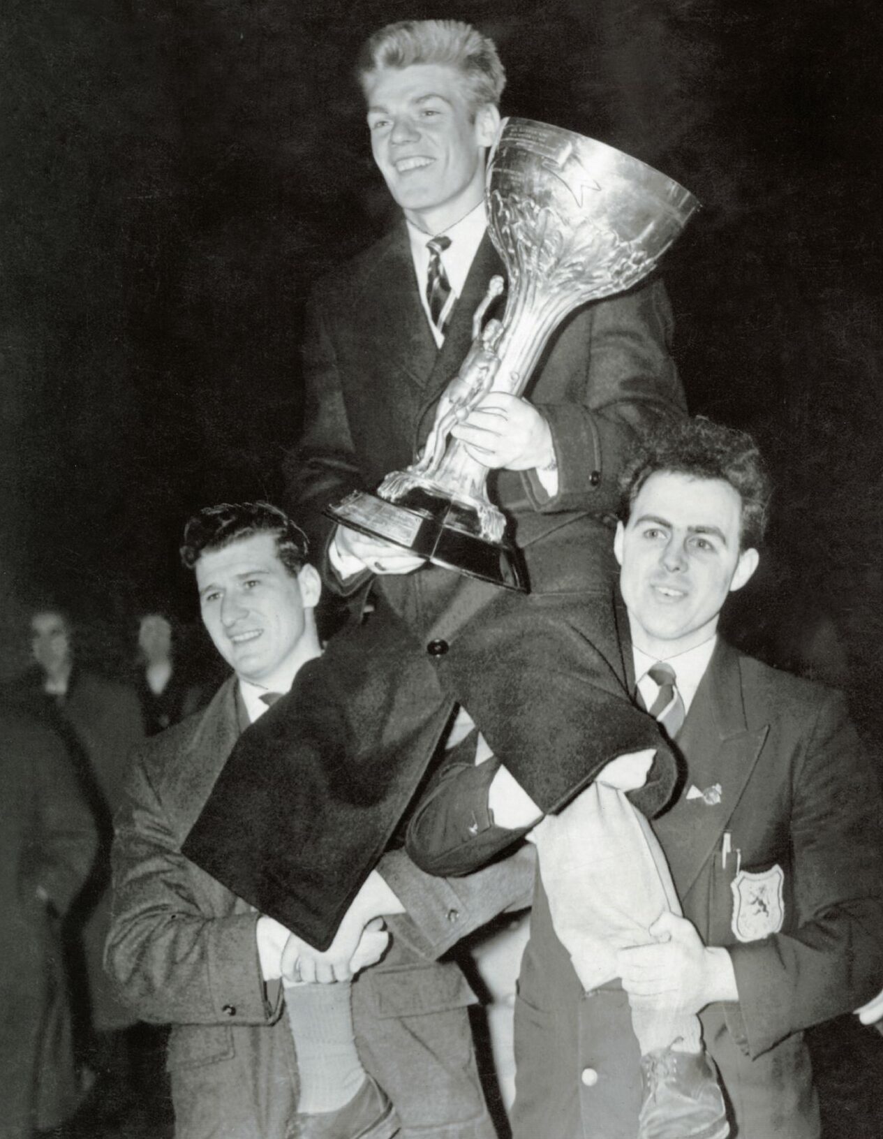 Dick McTaggart, being carried shoulder high, arrives back in Dundee with the gold medal and the Val Barker trophy. Image: DC Thomson.