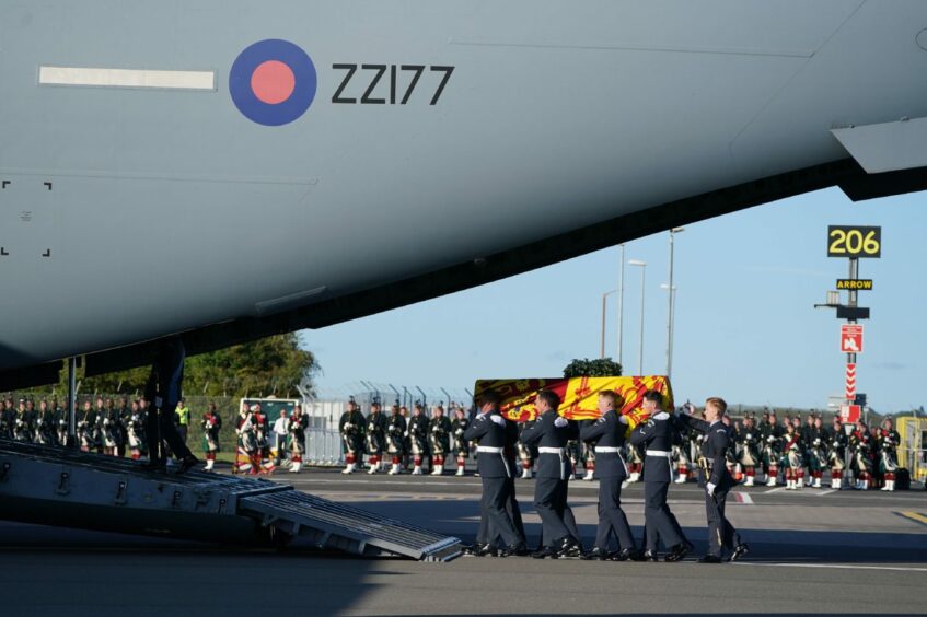 The coffin of Queen Elizabeth II is carried on to the plane. Image: Andrew Milligan/PA Wire.