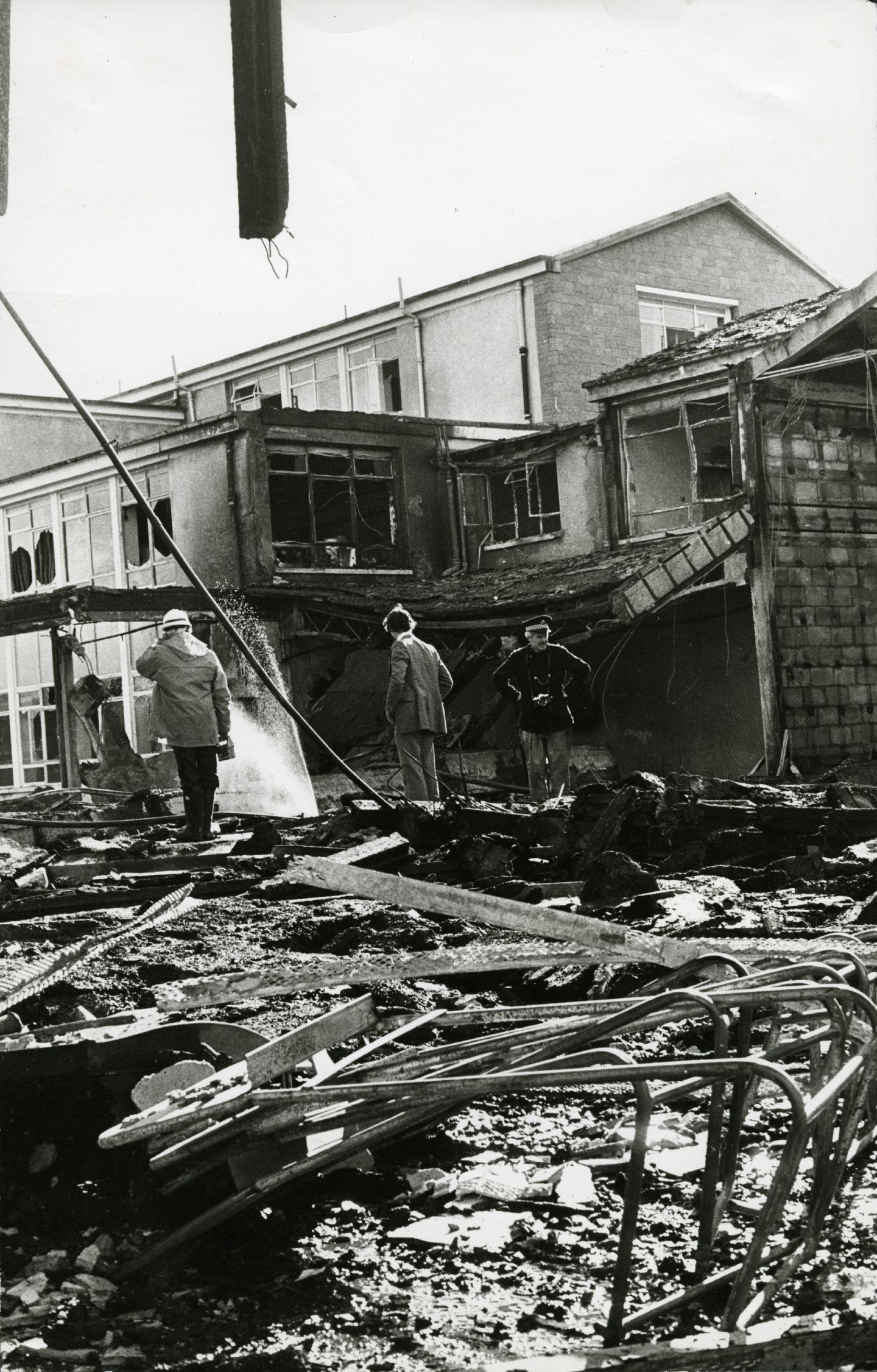 Firefighters and police looking through the wreckage. Image: DC Thomson.